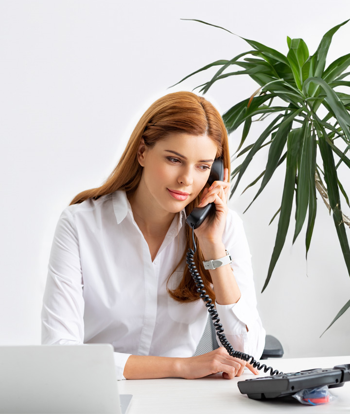Professional woman at work desk on phone
